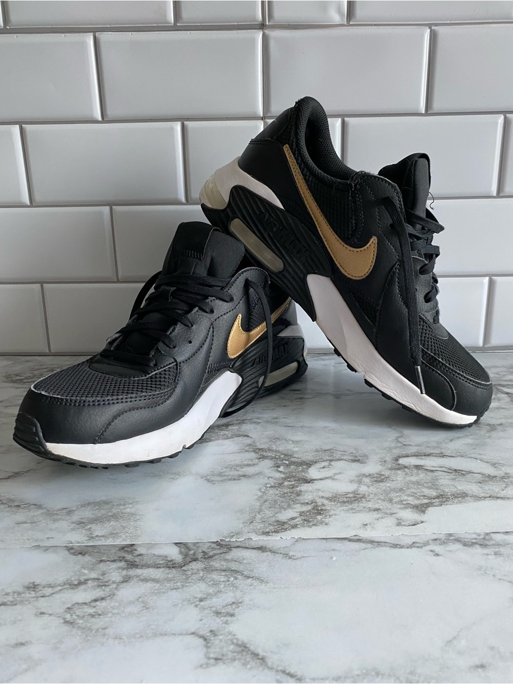 Nike Women’s Black Sneakers with Gold Swoosh